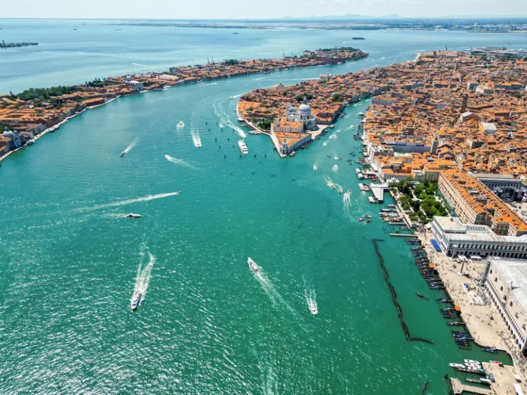 aerial-drone-view-venice-italy-water-channels-with-multiple-floating-moored-boats